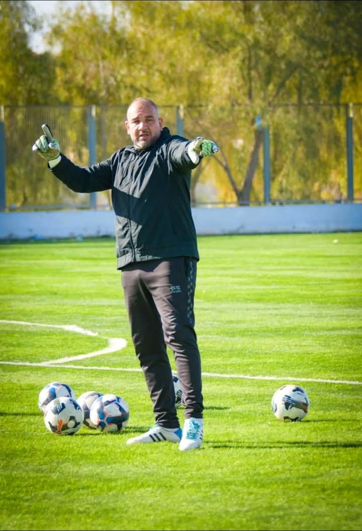 Raouf Rattouli donnant des instructions pendant une séance d'entraînement de gardiens, bras levés pour diriger le placement des joueurs.